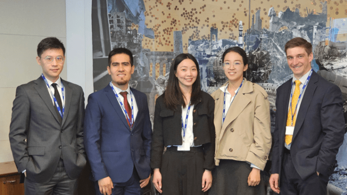 Peiju Li with her consulting project group, posing confidently in professional attire.